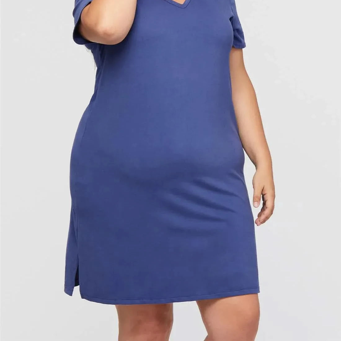 Plus-size woman smiling in a Marlin blue SOMÉ Eva V-neck sleepshirt, short sleeves, A-line silhouette.