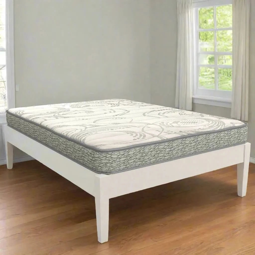 King Koil Tykes 5" foam mattress with a white and gray patterned top, on a white bed frame.