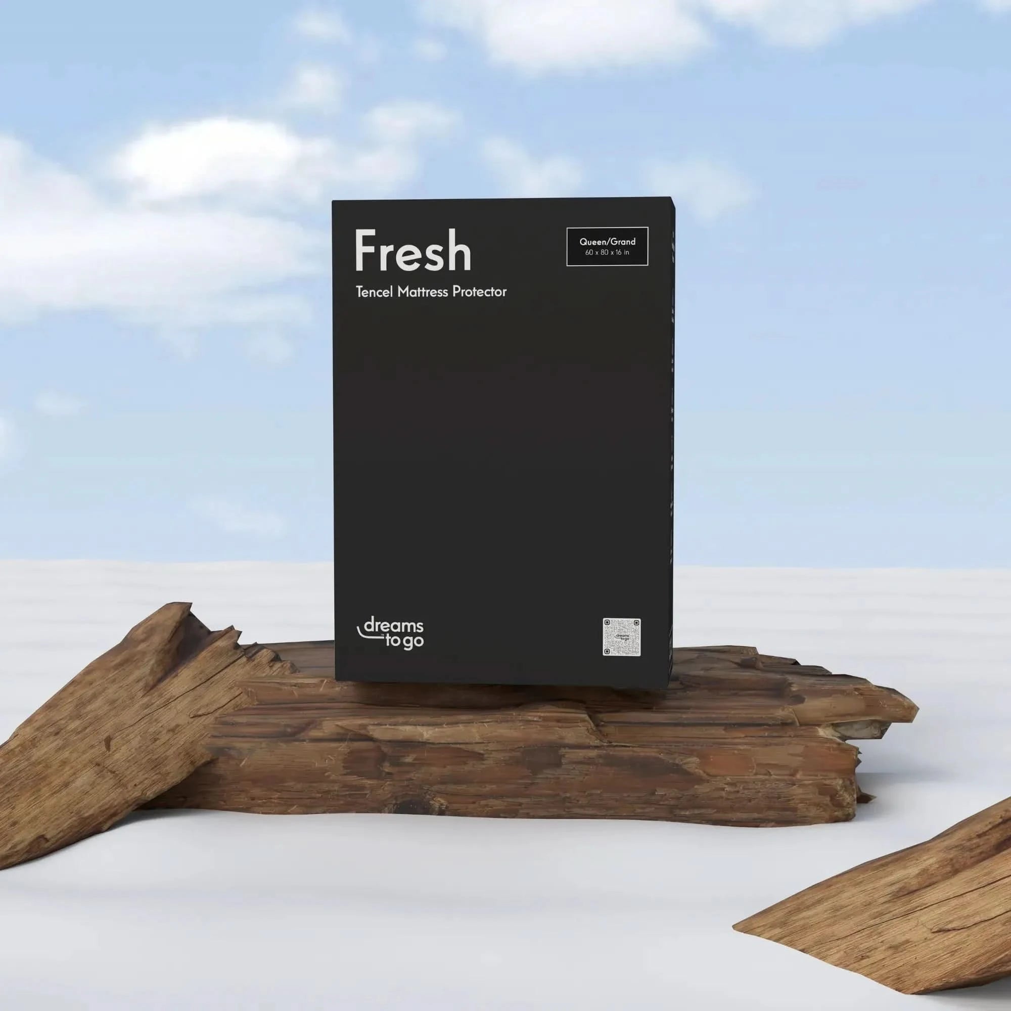 Black box for Dreams to Go Fresh Tencel Mattress Protector, Queen/Grand size, on natural wood.
