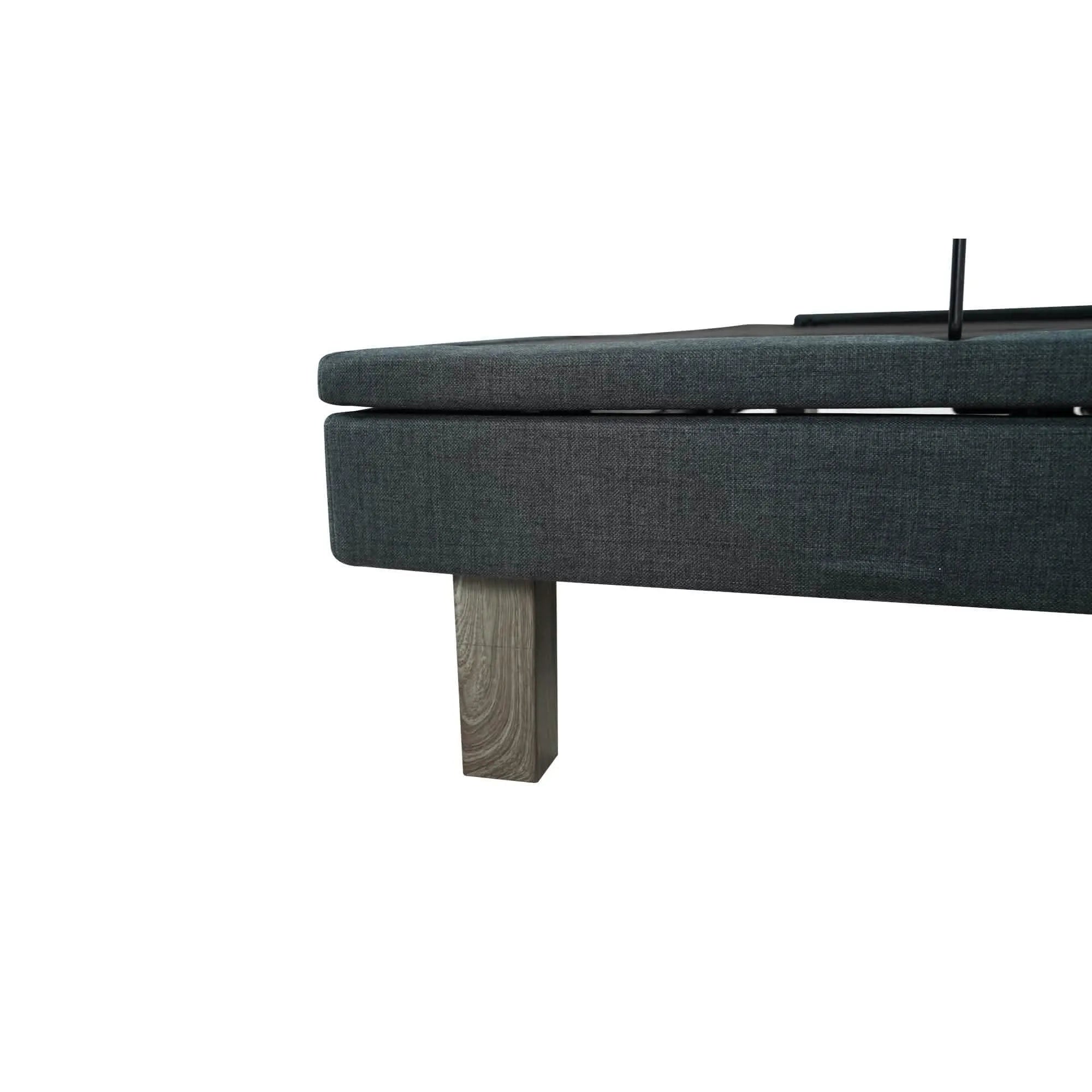 Ergomotion Exceed adjustable bed base, dark gray fabric, with a light wood-grain leg.